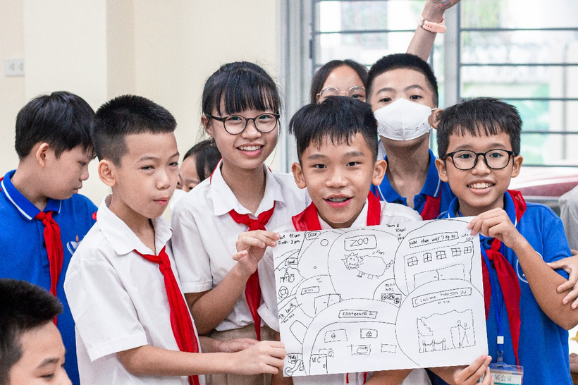 A group of children holding a piece of paperDescription automatically generated with medium confidence